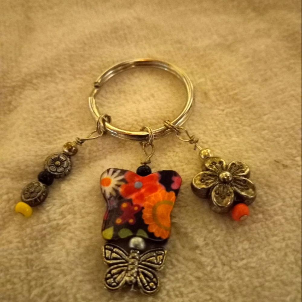 Handmade  printed on butterfly shell Keychain in black and pink and orange.